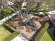 Aerial shot of a fenced playground with various play structures, offering children a fun and secure environment at 10013 Caraway Spice Ave, Riverview, FL 33578