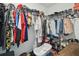 Spacious walk-in closet with ample hanging space, shoe racks, shelves, and various storage options at 10013 Caraway Spice Ave, Riverview, FL 33578