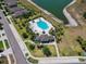 Aerial shot of the community pool, clubhouse, and parking. Lake views in the background at 10148 Rose Petal Pl, Riverview, FL 33578