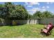 Spacious backyard features healthy grass, a privacy fence, and comfortable seating at 10148 Rose Petal Pl, Riverview, FL 33578