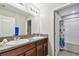 Bathroom with granite countertop, double sinks, and shower at 10148 Rose Petal Pl, Riverview, FL 33578