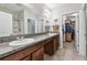 Bathroom features dual sinks with granite countertops, and a walk in closet at 10148 Rose Petal Pl, Riverview, FL 33578