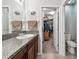 Bathroom with granite countertop vanity and walk-in closet/toilet area at 10148 Rose Petal Pl, Riverview, FL 33578