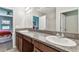 Granite countertop vanity with double sinks in bathroom near bedroom at 10148 Rose Petal Pl, Riverview, FL 33578