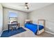 Bedroom featuring a bed frame, desk, and chair near a bright window with natural light at 10148 Rose Petal Pl, Riverview, FL 33578