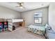 Bright bedroom featuring a bunk bed with storage and a twin bed, well-lit by a window at 10148 Rose Petal Pl, Riverview, FL 33578