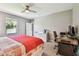 Cozy bedroom with a red comforter and a desk at 10148 Rose Petal Pl, Riverview, FL 33578