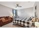 Bedroom with a fan, sofa, and black and white themed decor at 10148 Rose Petal Pl, Riverview, FL 33578