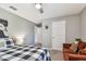 Bedroom with a fan, sofa, and white interior door at 10148 Rose Petal Pl, Riverview, FL 33578