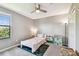 Comfortable bedroom featuring a twin bed, a large window and a ceiling fan at 10148 Rose Petal Pl, Riverview, FL 33578