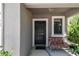 Inviting front porch with a black front door, a decorative light fixture, and a cushioned bench at 10148 Rose Petal Pl, Riverview, FL 33578