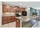 Stylish kitchen featuring dark wood cabinets, stainless steel appliances, and a functional island with bar seating at 10148 Rose Petal Pl, Riverview, FL 33578