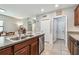 Bright kitchen with granite countertops, stainless steel dishwasher, and view of dining room at 10148 Rose Petal Pl, Riverview, FL 33578