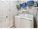 Functional laundry room with washer, dryer, shelving, and ample storage space at 10148 Rose Petal Pl, Riverview, FL 33578