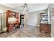 Living room with hardwood floors, ceiling fan, and shelves at 10148 Rose Petal Pl, Riverview, FL 33578
