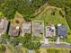An aerial view captures a cozy home nestled among lush greenery and a well-maintained lawn at 1015 S Pointe Alexis Dr, Tarpon Springs, FL 34689