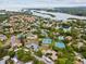 Stunning aerial view of a residential community with tennis courts and lush landscaping near the water at 1015 S Pointe Alexis Dr, Tarpon Springs, FL 34689