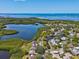 Desirable waterfront home with scenic lake views and tranquil surroundings from an aerial perspective at 1015 S Pointe Alexis Dr, Tarpon Springs, FL 34689