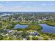 An aerial shot shows a beautiful home nestled amidst serene lakes, offering a tranquil living environment at 1015 S Pointe Alexis Dr, Tarpon Springs, FL 34689