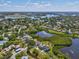 A bird's eye view captures this lovely home by a tranquil lake offering a serene living experience at 1015 S Pointe Alexis Dr, Tarpon Springs, FL 34689