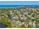 Beautiful waterfront home offering serene lake views and convenient access to community amenities, an aerial view at 1015 S Pointe Alexis Dr, Tarpon Springs, FL 34689