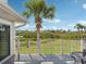 Scenic backyard view from the patio, featuring palm trees and tranquil water views at 1015 S Pointe Alexis Dr, Tarpon Springs, FL 34689
