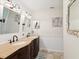 Elegant bathroom featuring a double vanity with a curved countertop, ample cabinet storage, and stylish lighting fixtures at 1015 S Pointe Alexis Dr, Tarpon Springs, FL 34689