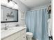 Charming bathroom featuring a vanity with a marble countertop and an enclosed shower with decorative accents at 1015 S Pointe Alexis Dr, Tarpon Springs, FL 34689