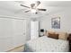 Bright bedroom with a ceiling fan, spacious closet, and neutral tones creating a comfortable and serene retreat at 1015 S Pointe Alexis Dr, Tarpon Springs, FL 34689