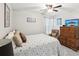 Relaxing bedroom featuring neutral paint, ceiling fan, flat screen TV and cozy textures creating inviting space at 1015 S Pointe Alexis Dr, Tarpon Springs, FL 34689