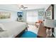 Bright bedroom with a serene coastal vibe, featuring a comfortable armchair and large window at 1015 S Pointe Alexis Dr, Tarpon Springs, FL 34689