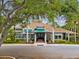 Beautiful clubhouse exterior with well-maintained landscaping, mature trees, and a welcoming entrance at 1015 S Pointe Alexis Dr, Tarpon Springs, FL 34689