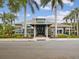 Welcoming clubhouse exterior framed by swaying palm trees and lush landscaping at 1015 S Pointe Alexis Dr, Tarpon Springs, FL 34689