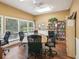 Well-lit conference room with large table, office chairs, and bookshelves at 1015 S Pointe Alexis Dr, Tarpon Springs, FL 34689