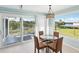 Cozy dining area with waterfront views and sliding doors to the outdoor deck at 1015 S Pointe Alexis Dr, Tarpon Springs, FL 34689