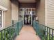 Entrance to clubhouse with inviting double doors, walkway, and lush landscaping at 1015 S Pointe Alexis Dr, Tarpon Springs, FL 34689
