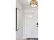 Clean entryway with a textured accent wall, a glass-paneled door and an overhead light at 1015 S Pointe Alexis Dr, Tarpon Springs, FL 34689