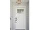 Stylish front door with decorative glass panel and modern smart lock at 1015 S Pointe Alexis Dr, Tarpon Springs, FL 34689