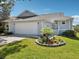 Charming single Gathering home with a well-maintained front yard and a two-car garage at 1015 S Pointe Alexis Dr, Tarpon Springs, FL 34689