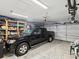Spacious garage with ample room for parking and storage, including a truck, shelves and an overhead bike rack at 1015 S Pointe Alexis Dr, Tarpon Springs, FL 34689