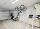 Spacious garage with bicycle rack, storage cabinets, and access to the home at 1015 S Pointe Alexis Dr, Tarpon Springs, FL 34689