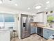 Kitchen featuring two-tone cabinetry, stainless steel appliances, wood countertops, and natural light at 1015 S Pointe Alexis Dr, Tarpon Springs, FL 34689