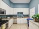 Bright kitchen featuring white cabinets, granite countertops, stainless steel appliances, and ample storage at 1015 S Pointe Alexis Dr, Tarpon Springs, FL 34689