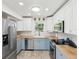 Kitchen featuring stainless steel appliances, two-tone cabinets, tile floors, and wood countertops at 1015 S Pointe Alexis Dr, Tarpon Springs, FL 34689