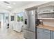 Kitchen featuring stainless steel refrigerator, tile floors, and an island with counter seating at 1015 S Pointe Alexis Dr, Tarpon Springs, FL 34689
