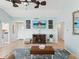 Stylish living room with a fireplace, a TV and beach themed decorations at 1015 S Pointe Alexis Dr, Tarpon Springs, FL 34689