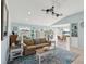 Bright open-concept living space with water views from the windows and access to the back deck at 1015 S Pointe Alexis Dr, Tarpon Springs, FL 34689