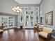 Inviting lobby with hardwood floors, a chandelier, and comfortable seating, creating a welcoming atmosphere at 1015 S Pointe Alexis Dr, Tarpon Springs, FL 34689