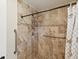 Updated shower with decorative tile, installed grab bars, hand shower, and updated shower head at 1015 S Pointe Alexis Dr, Tarpon Springs, FL 34689