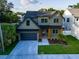 Aerial view of two-story home featuring two-car garage, neat landscaping, and inviting front porch at 1017 W Charter St, Tampa, FL 33602